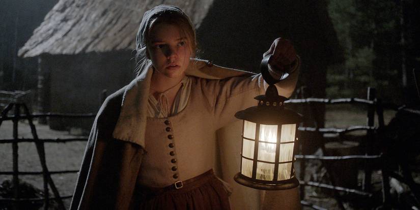 Anya Taylor-Joy as Thomasin holding a lantern at night in The Witch