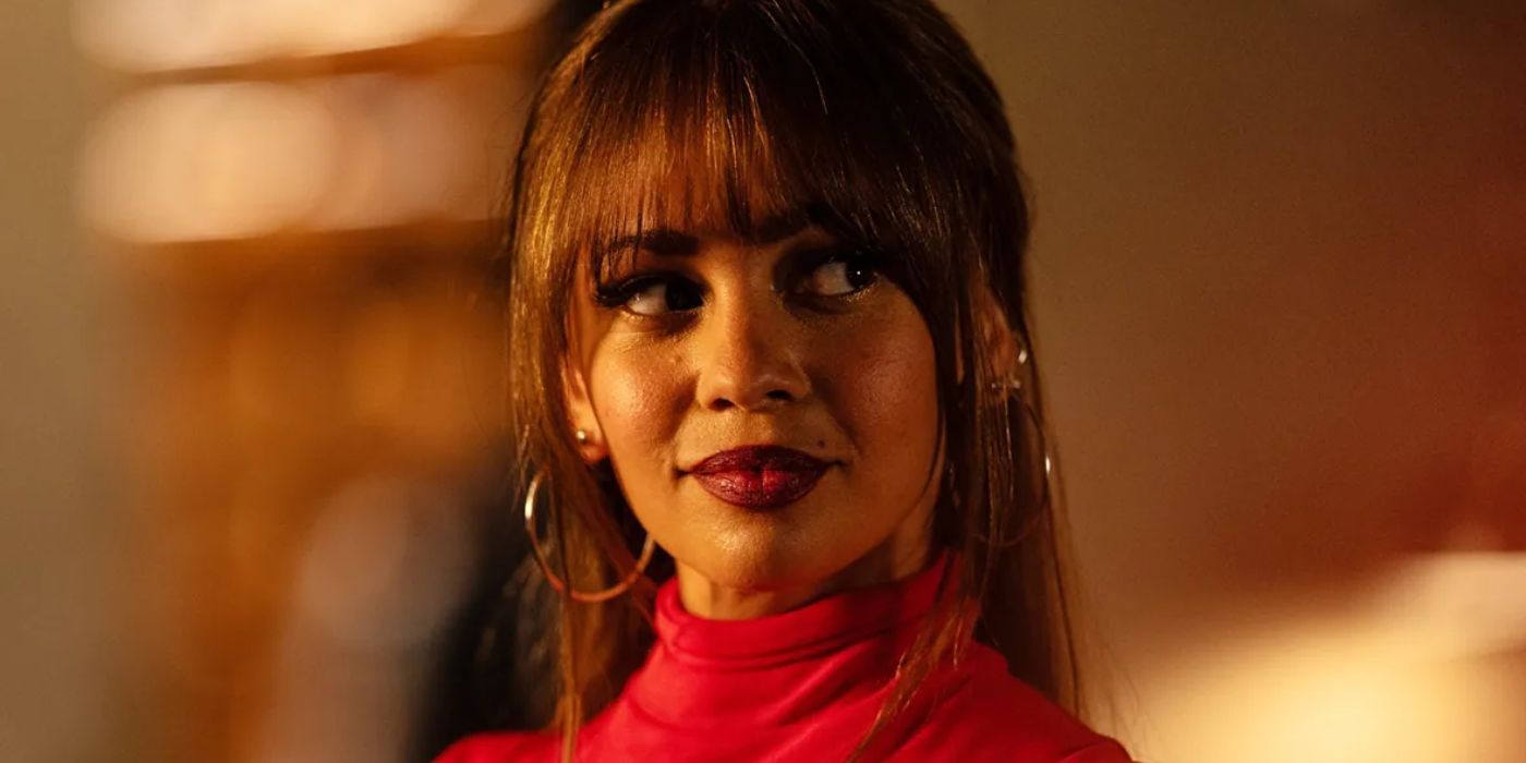 Vanessa Morgan wearing red and looking at a person offscreen in 'Wild Cards'