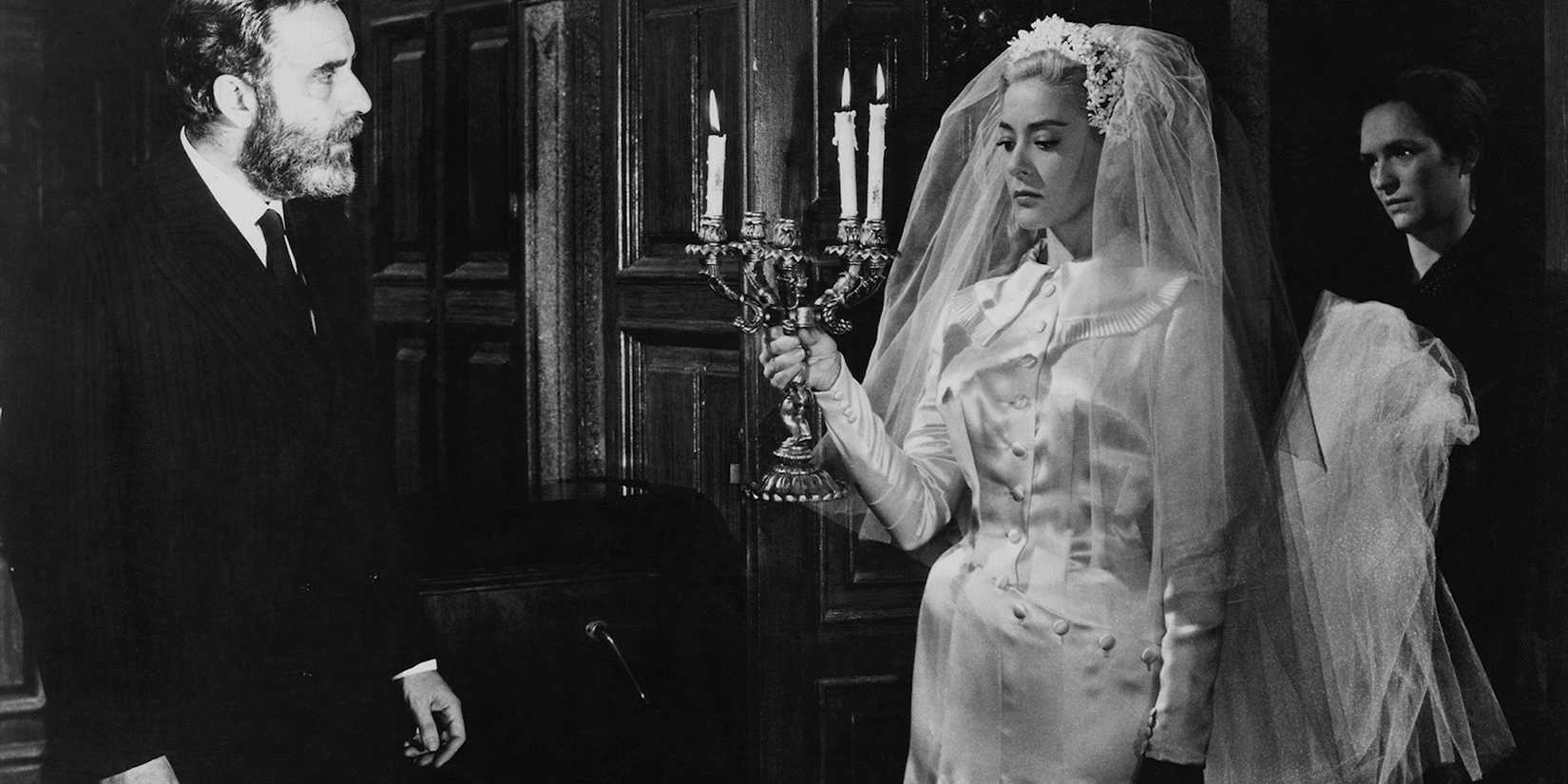 Viridiana in a wedding dress facing a man in Viridiana 19610