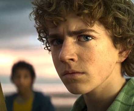 Walker Scobell as Percy Jackson holding a sword in Percy Jackson and the Olympians TV series.