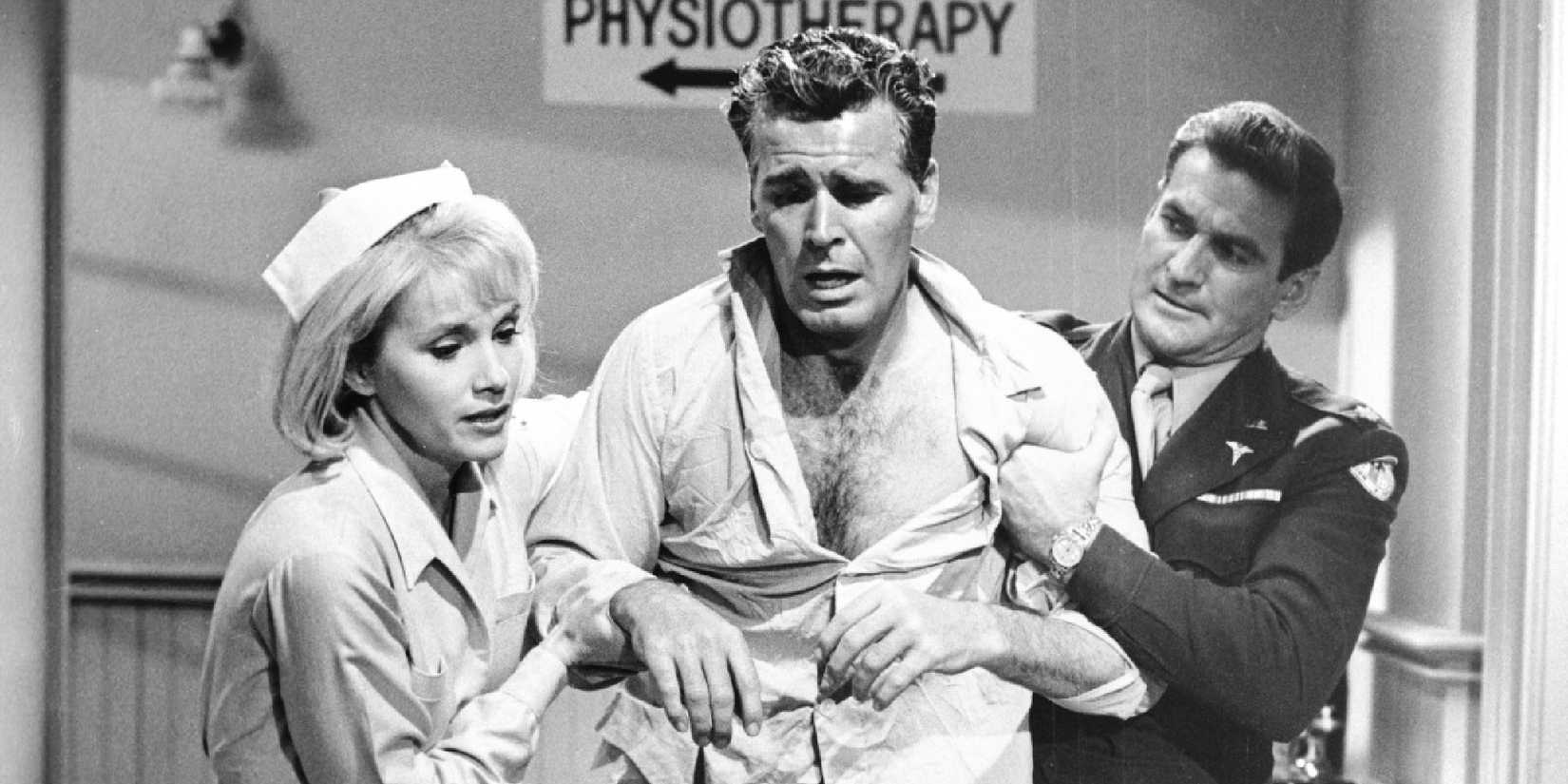 A nurse and a soldier helping a distressed looking man in 36 Hours