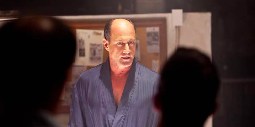 Leo Durocher (Christopher Meloni) stands in his dressing gown addressing the players of his baseball team.