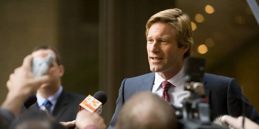 Aaron Eckhart as Harvey Dent addressing reporters in The Dark Knight