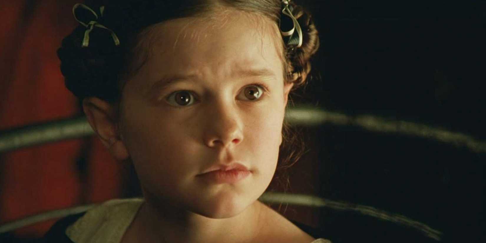 a young Anna Paquin with buns in The Piano