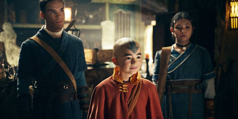 Gordon Cormier as Aang with Ian Ousley as Sokka and Kiawentiio as Katara standing behind him in Avatar the Last Airbender