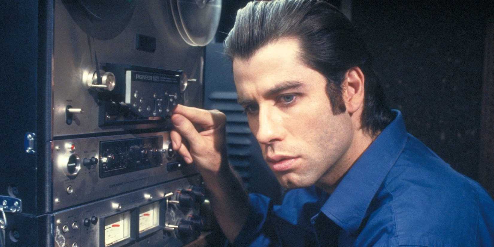 Jack Terry looking pensive besides a film camera in the film Blow Out - 1981