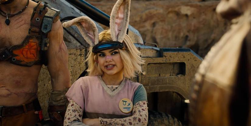Ariana Greenblatt as Tiny Tina with folded arms, talking to someone off camera in Borderlands.