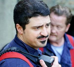 A firefighter talking to a radio