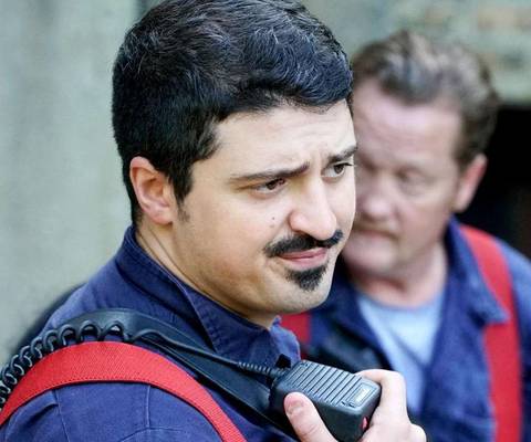 A firefighter talking to a radio