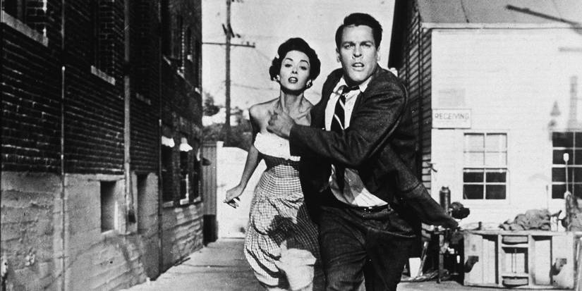 Dana Wynter and Kevin McCarthy as Becky and Myles, running in Invasion of the Body Snatchers