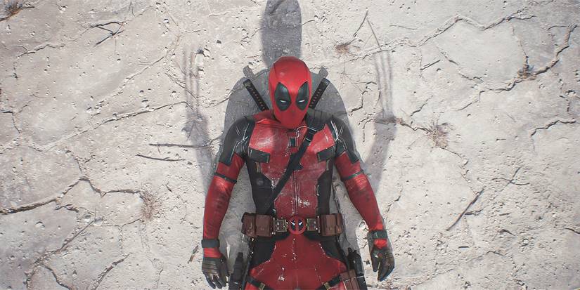Deadpool on the ground with Wolverine's shadow over him in Deadpool and Wolverine