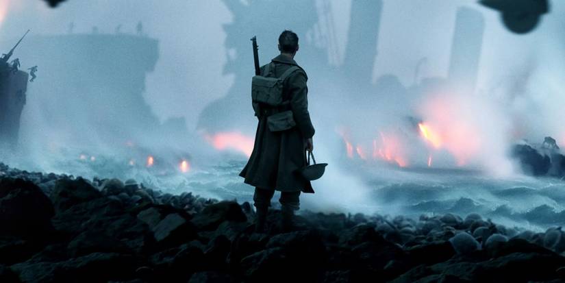 A man stares at a burning shipwreck in Dunkirk
