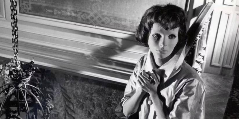 A woman wears an expressionless white mask in Eyes Without A Face (1960)