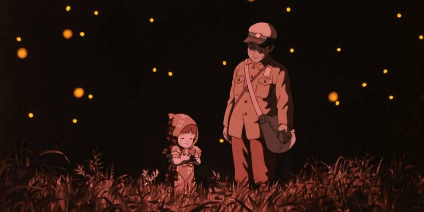 Seita and Setsuko walk in a field of flowers and fireflies in Grave of the Fireflies.