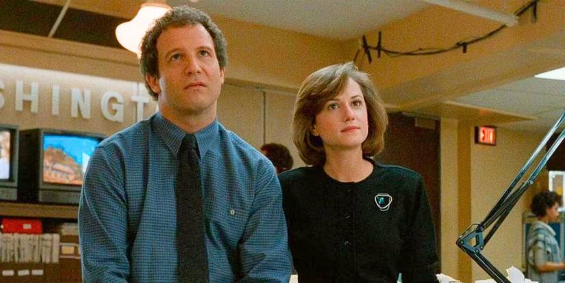 Jane and Arron look on in Broadcast News