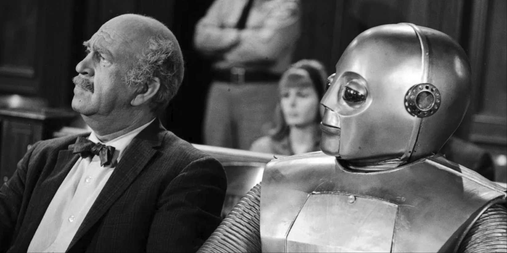 A man sitting next to a robot in Outer Limits