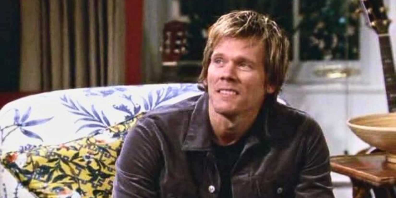 Kevin Bacon sitting on a couch in Will & Grace