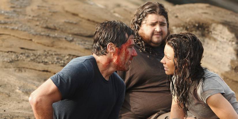 Kate Austen (Evangeline Lilly) looks at a bloodied Jack Shephard (Matthew Fox), while Hugo "Hurley" Reyes (Jorge Garcia) looks on in Lost