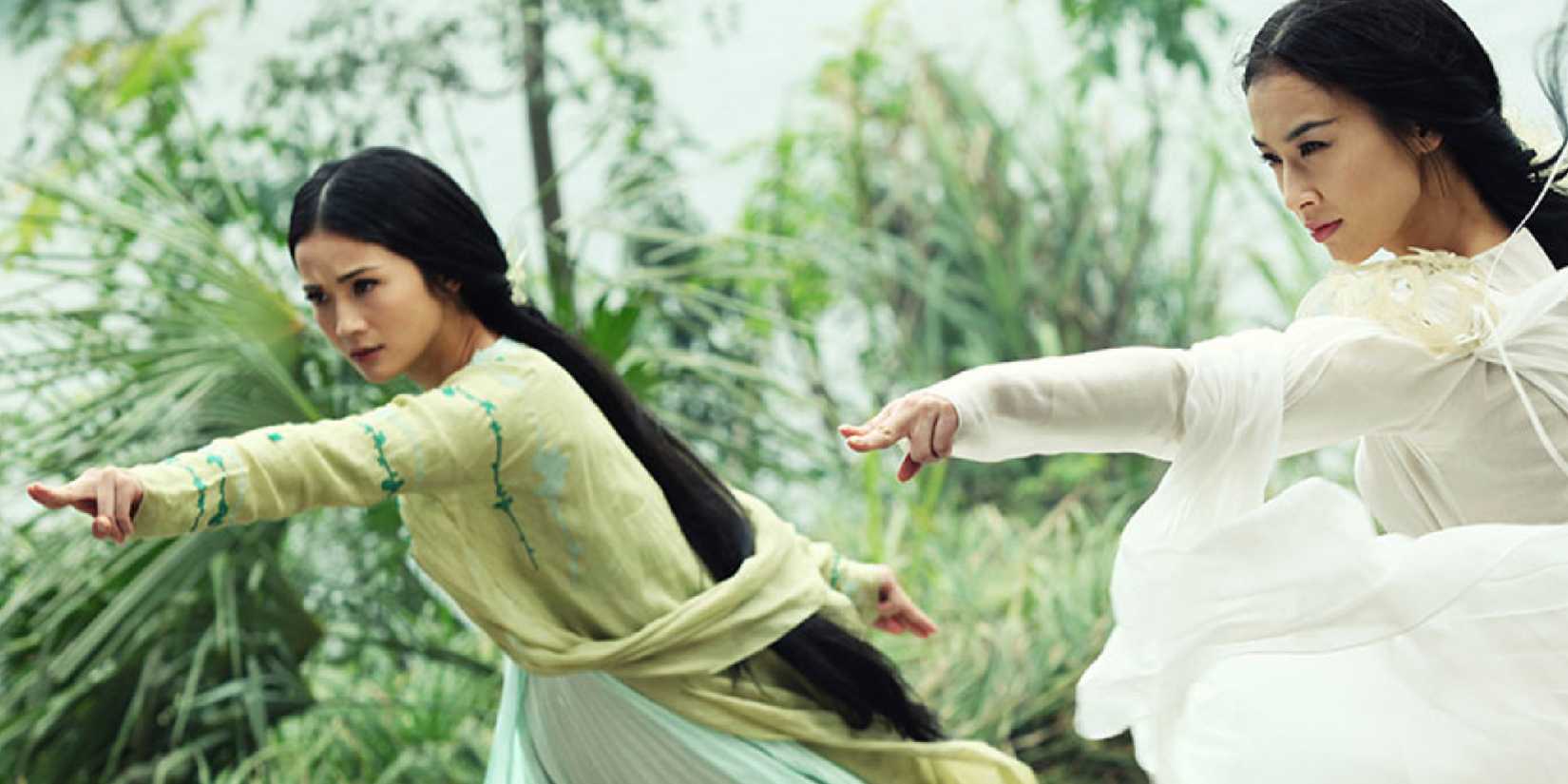 Maggie Cheung and Joey Wong in matching stances with determined expressions in Green Snake.