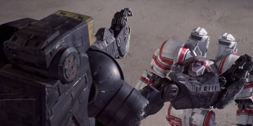 A mech kicks another mech to the ground in Robot Jox