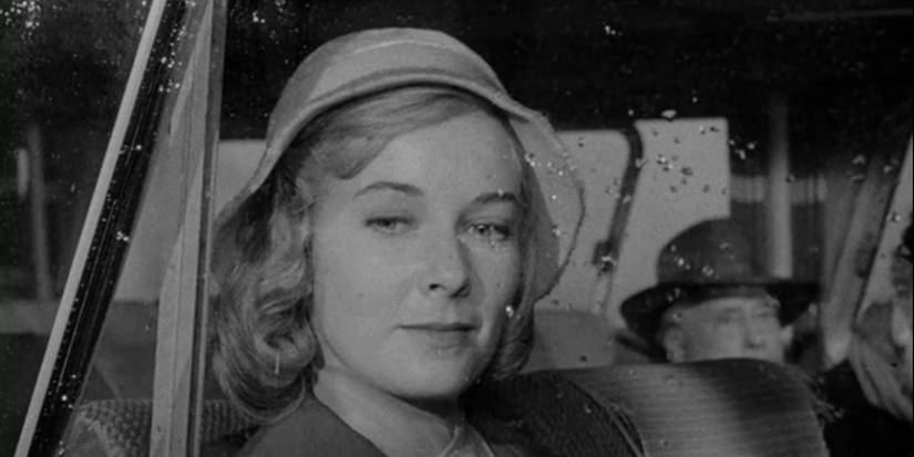 Vera Miles looking out a rainy window in the Mirror Image episode of The Twilight Zone.