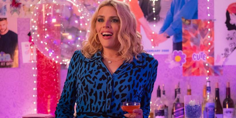 Busy Philipps wears a blue leopard print shirt and holds a cocktail in 'Girls5Eva'