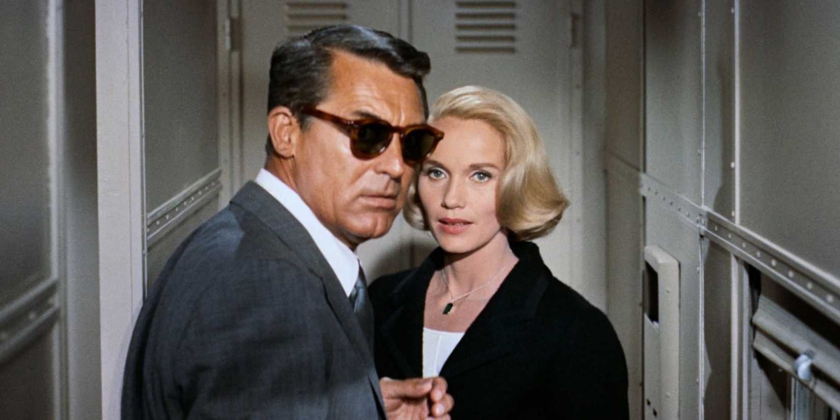 Cary Grant and Eve Marie Saint as Roger and Eve in a train aisle, staring towards the camera
