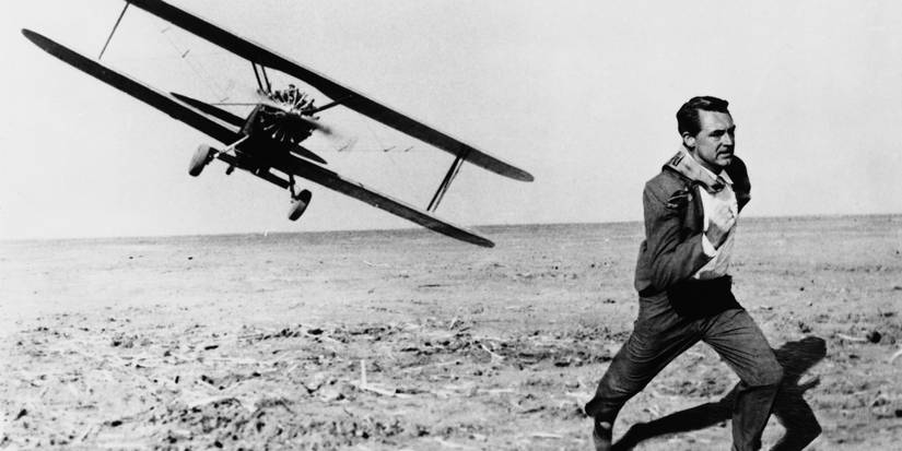 Cary Grant as Roger Thornhill, wearing a suit and running away from a crop duster plane in North by Northwest