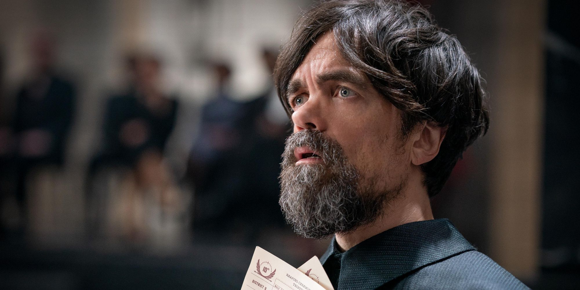 Peter Dinklage as Dean Highbottom looks shocked in 'The Hunger Games: The Ballad of Songbirds and Snakes'