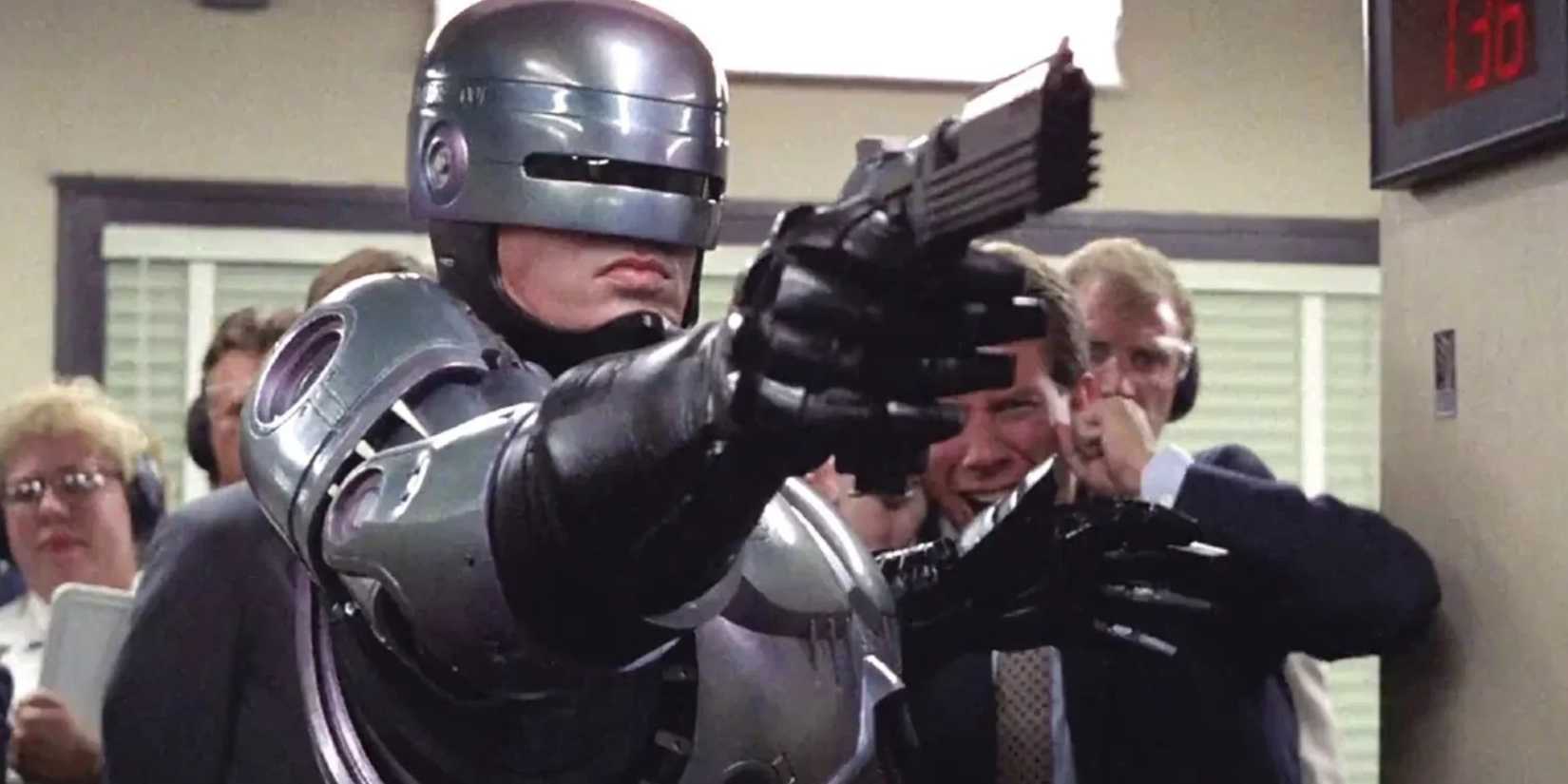 Robocop (Peter Weller) menembakkan pistolnya ke lapangan tembak di depan orang banyak di 'Robocop'