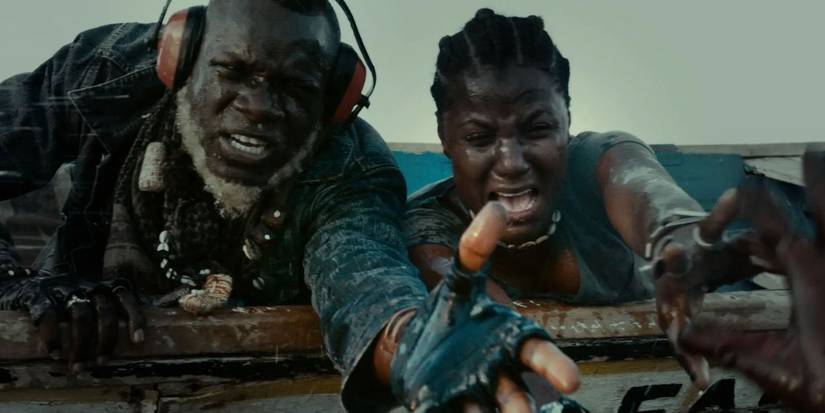 A man and a woman reach out to grab someone's hand