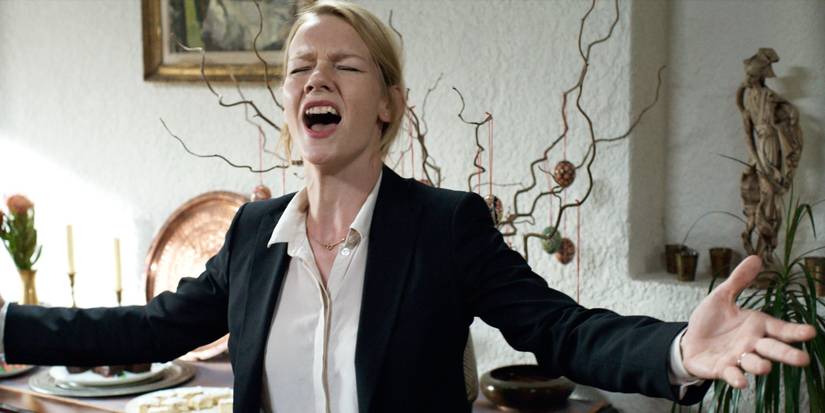 Sandra Huller singing with outstretched arms in Toni Erdmann.