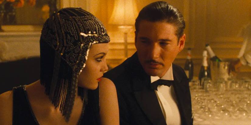 Diane Lane & Richard Gere look at one another lustfully as they sit in a hotel room surrounded by champagne bottles