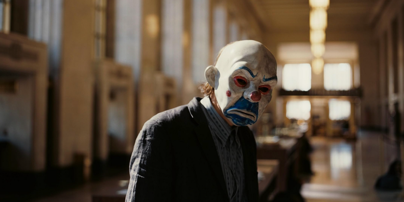 The Joker (Heath Ledger) in a clown mask at the beginning of 'The Dark Knight'