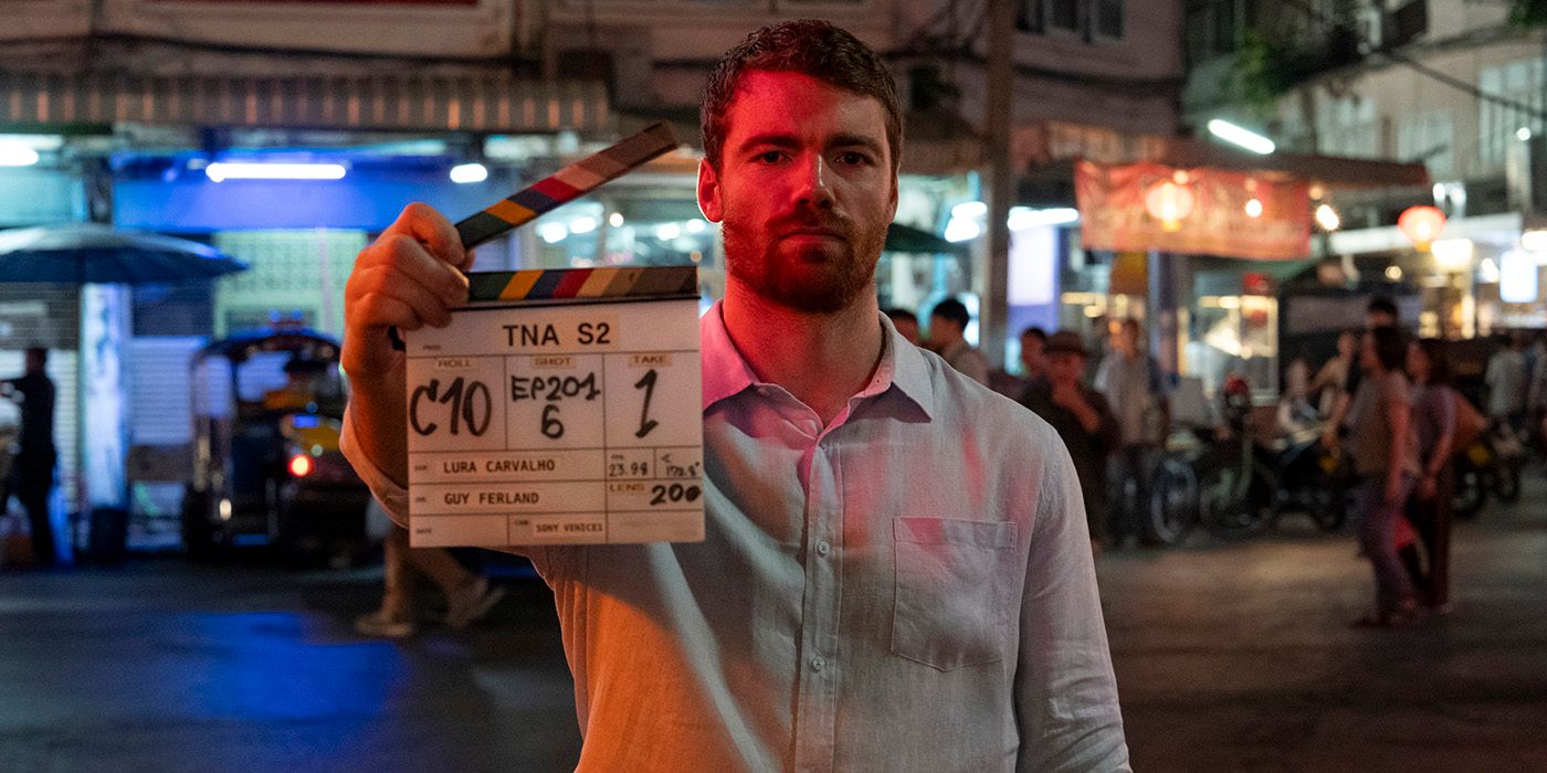 Gabriel Basso holding a clapper on set for The Night Agent Season 2