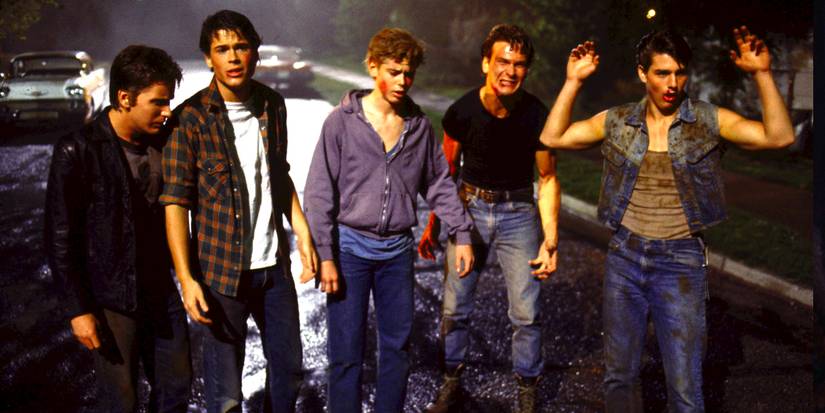 Five teenagers walk down the street in the night, all of them looking tired and bloodied.