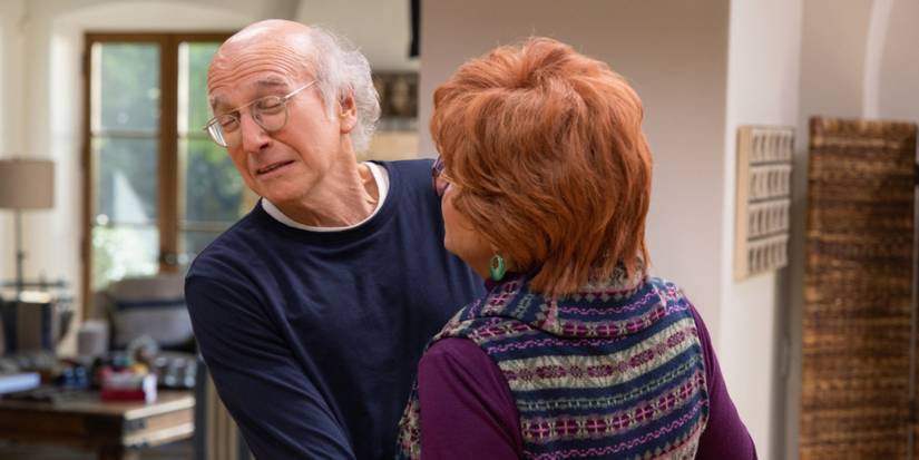 Tracey Ullman leaning in to kiss Larry David while he cringes in Curb Your Enthusiasm