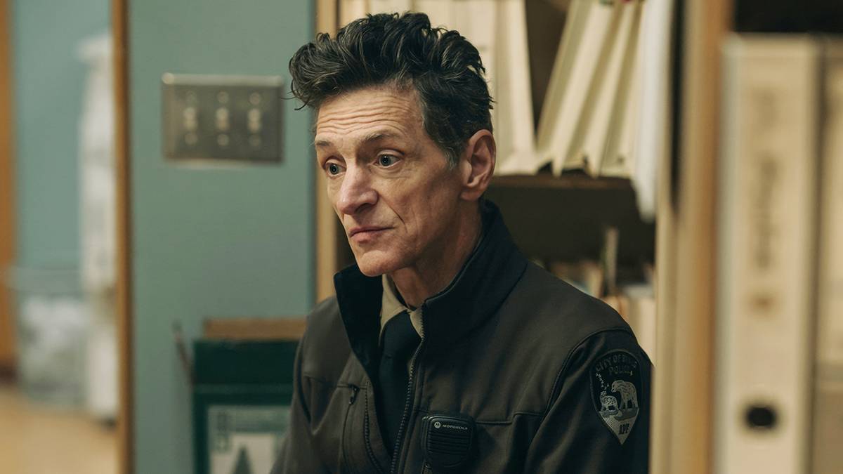 John Hawkes as Hank Prior wearing his police uniform and looking at something off screen in True Detective: Night Country Episode 5. 
