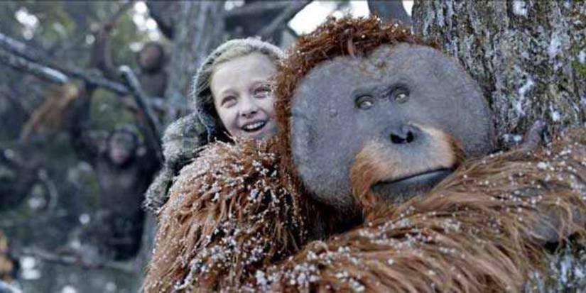 Amiah Miller carries a smiling Karin Konoval on his back in War for the Planet of the Apes