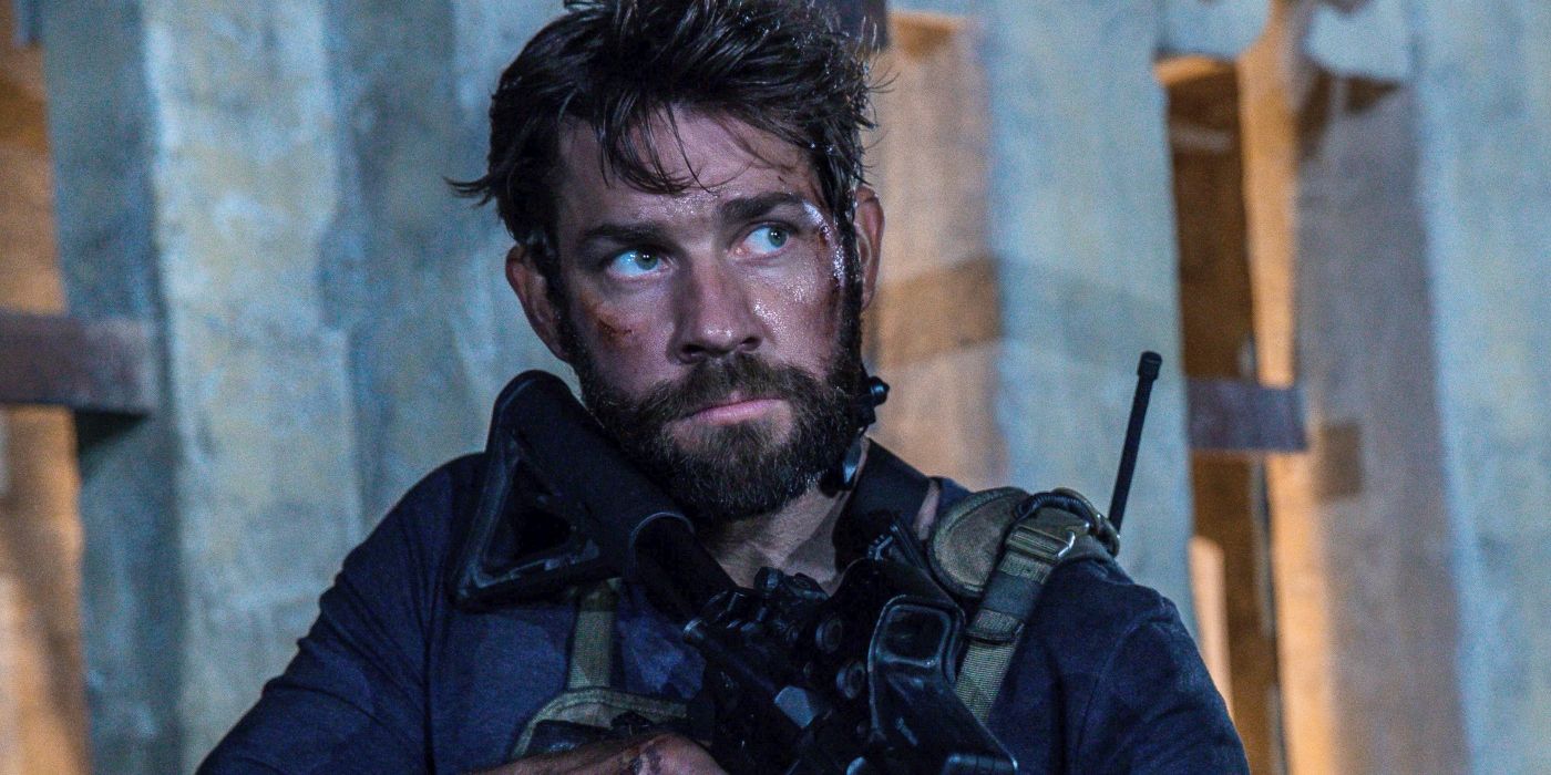 Jack Silva holding a gun and looking intently ahead in 13 Hours: The Secret Soldiers of Benghazi