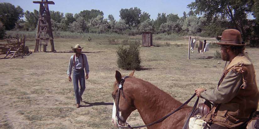 Peter Fonda as Harry Calling approaches a man on a horse in The Hired Hand