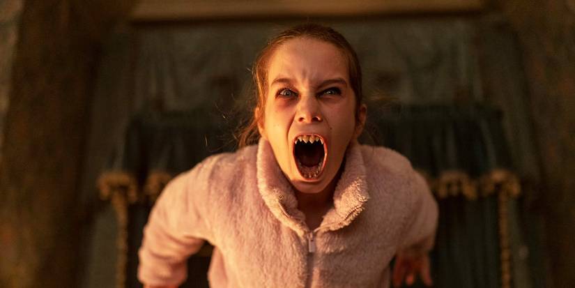 Alisha Weir bearing her vampire teeth in Abigail.