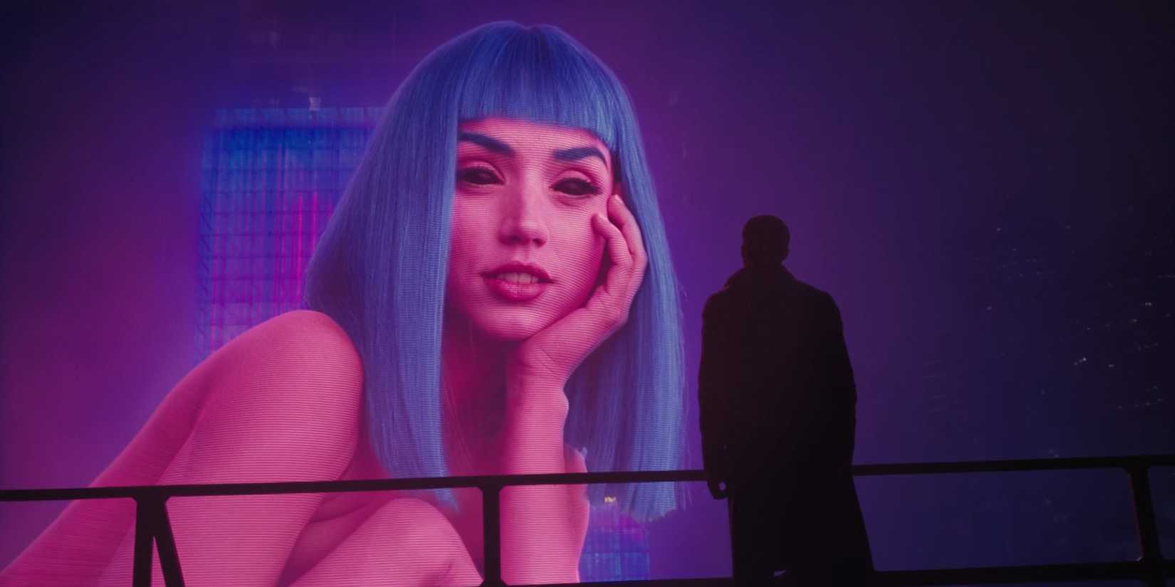 A giant hologram of Joi, looking at Ryan Gosling as K in Blade Runner 2049.