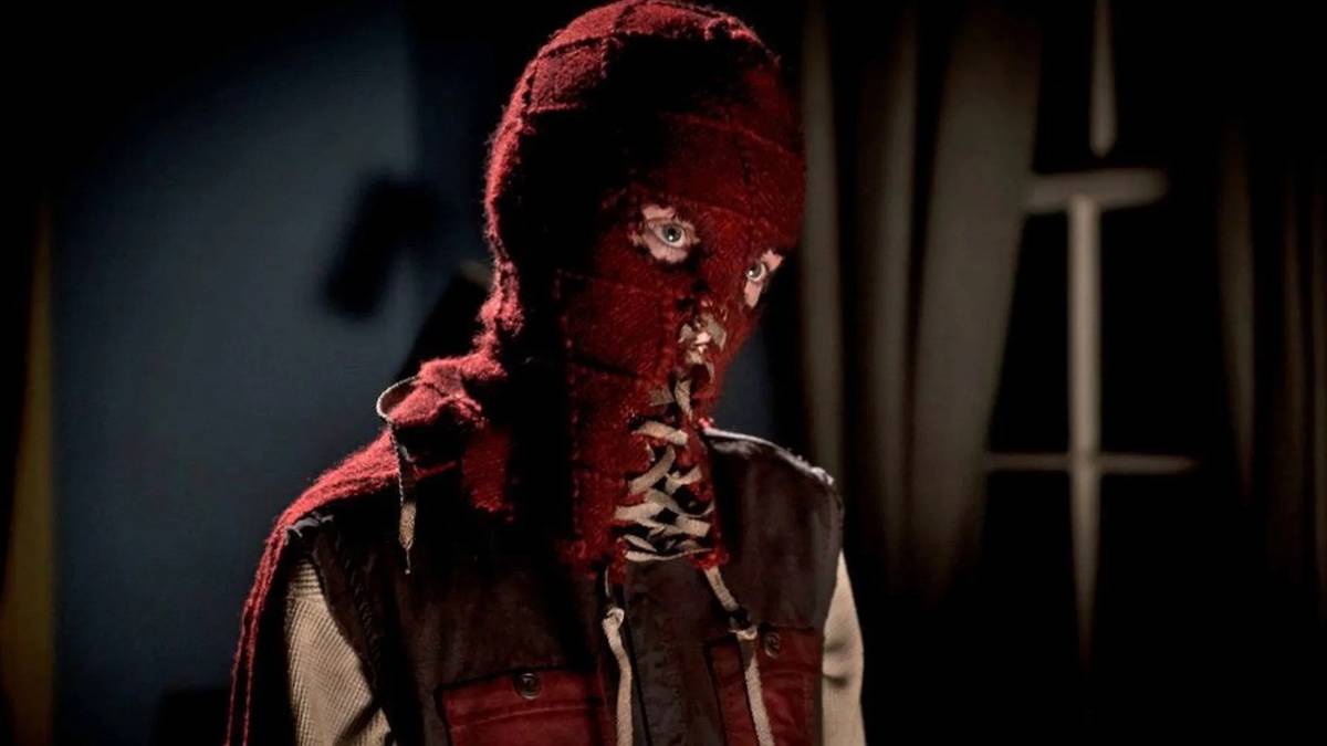 Brightburn, in costume, looks at someone off-camera with his head tilted 