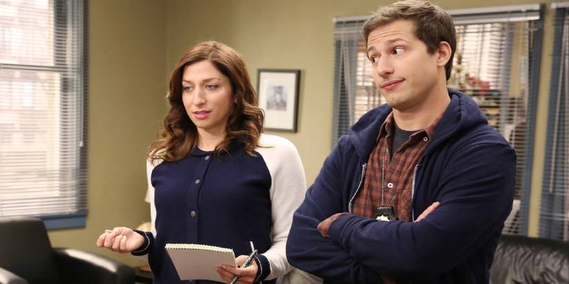 Gina (Chelsea Peretti) and Jake (Andy Samberg) in the captain's office in Brooklyn Nine-Nine.