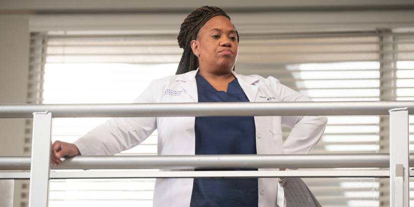 Chandra Wilson as Dr. Miranda Bailey in Season 20 of 'Grey's Anatomy,' standing on a balcony, observing the hospital floor below.