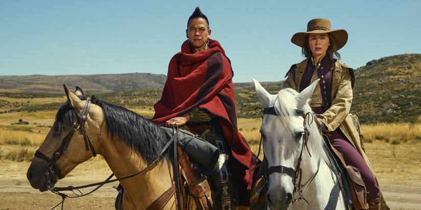 Chaske Spencer and Emily Blunt riding horses together in The English.