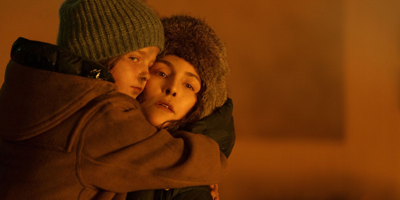 Rosie/Davina Coleman and Noomi Rapace stand illuminated by fire in Constellation