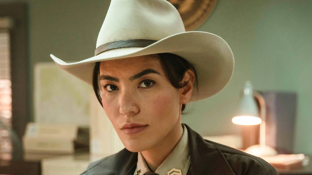 Jessica Matten as Bernadette Manuelito wearing a cowboy hat in the police station in Dark Winds