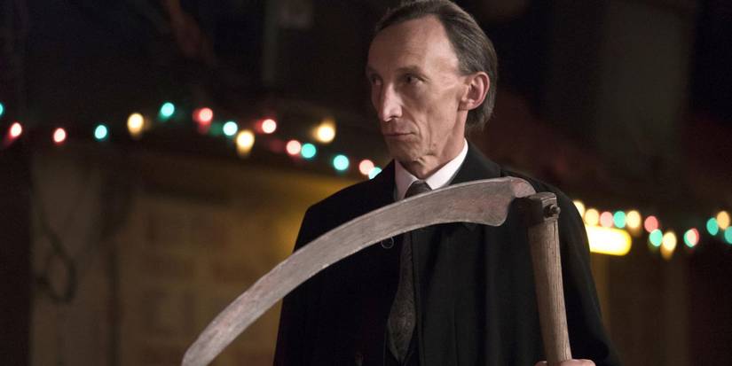 Death (Julian Richings) stands in a bar with his scythe at the ready in 'Supernatural'.